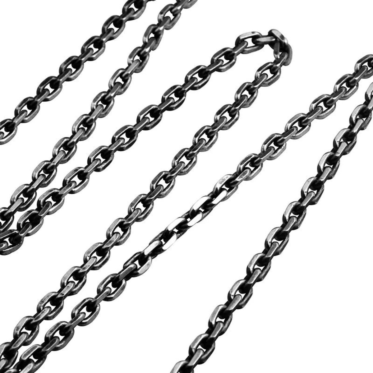 A detailed studio shot focusing entirely on the intricate chain texture, showcasing the links of the matching sterling silver necklace