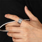 Adjustable 990 fine silver dragon ring with Heart Sutra engraving worn on a finger, close up view