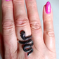 Adjustable sterling silver snake ring on finger