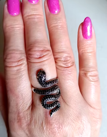 Adjustable sterling silver snake ring on finger