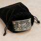 Antique finish silver cuff with raised lotus flower design inside velvet black gift bag