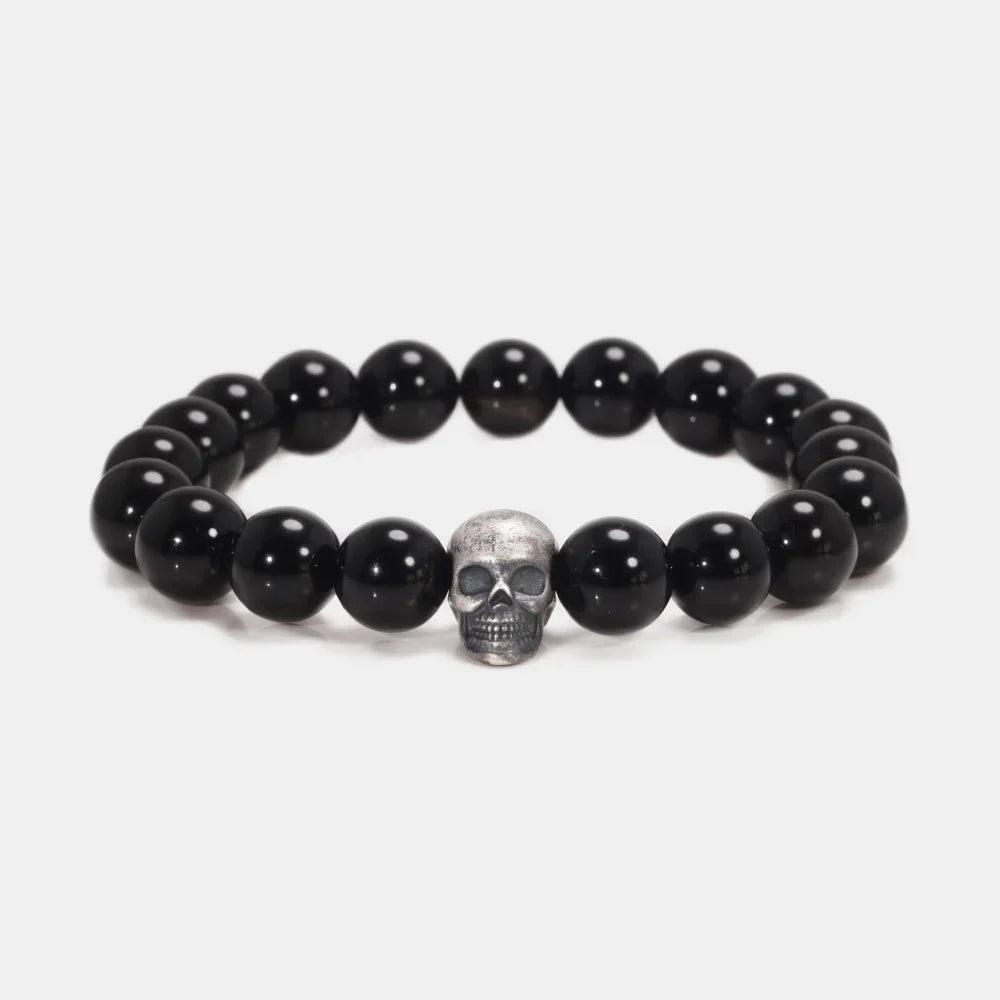 Black natural stone bead bracelet with centered sterling silver skull bead, front view