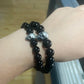 Black natural stone skull bead bracelet worn on the wrist