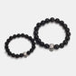 Black stone bead bracelet with sterling silver skull bead, shown in two sizes