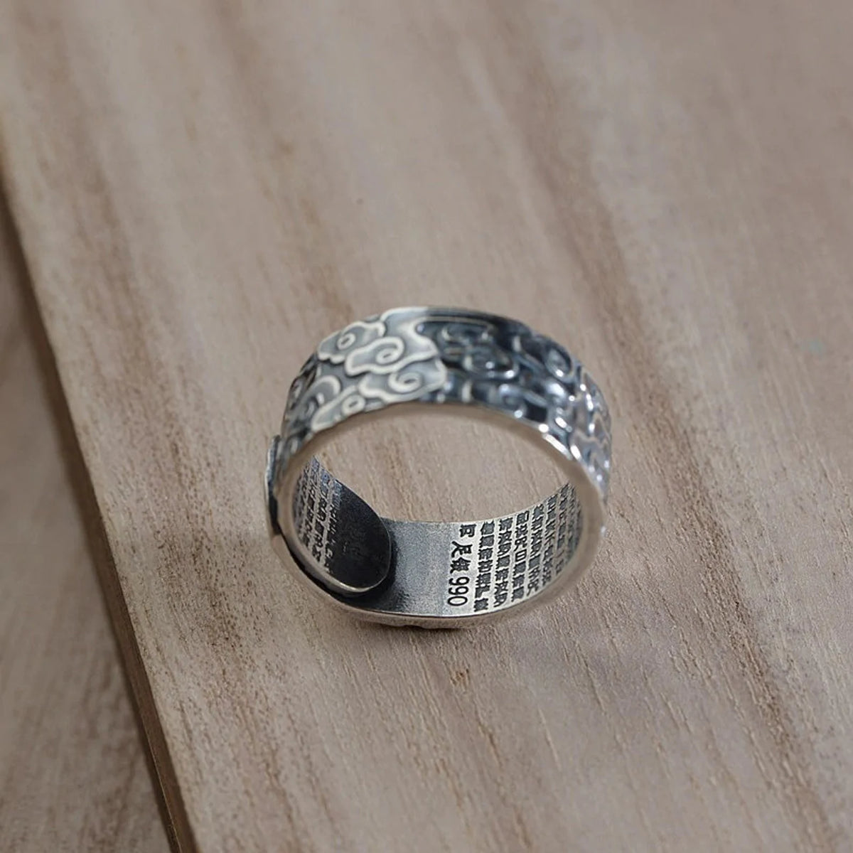 Buddhist silver ring with lucky clouds side angle