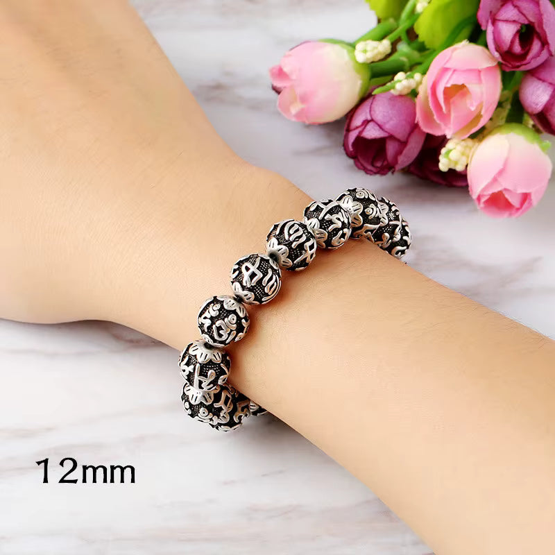 Chunky Sanskrit engraved Tibetan silver bead bracelet on woman wrist