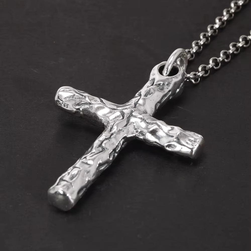 Close up of the textured sterling silver cross pendant
