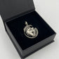 Detailed oxidized silver mermaid and child charm inside black jewelry box
