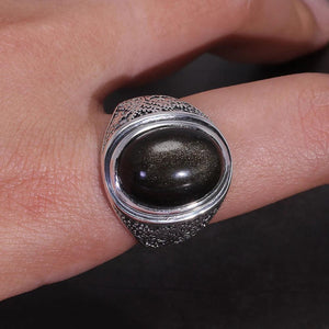 Golden sheen gemstone ring on finger