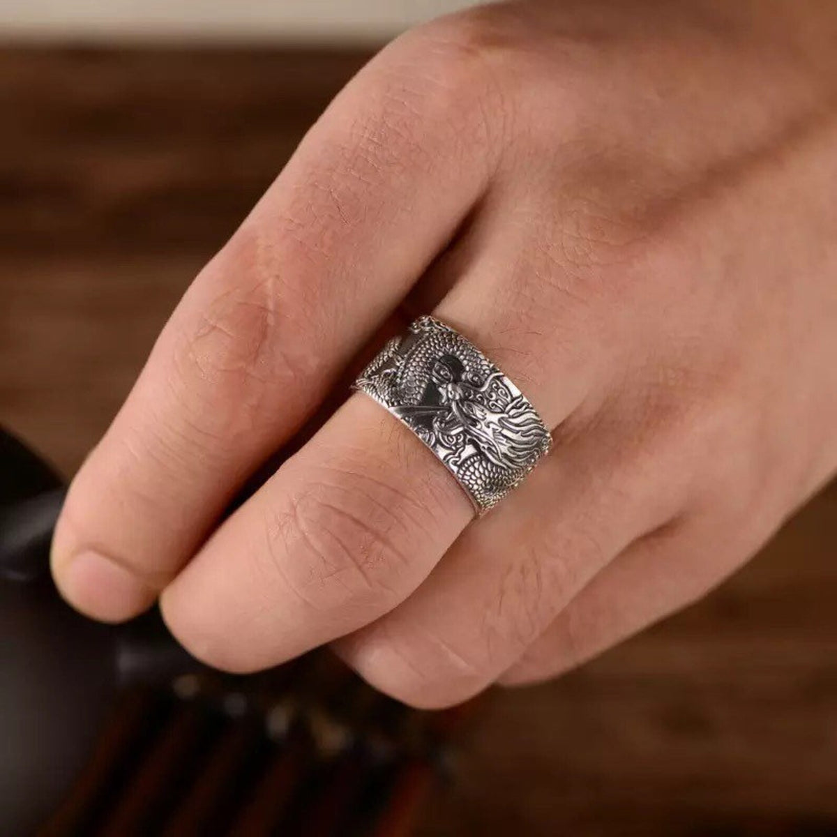 Heart Sutra dragon ring worn on a finger