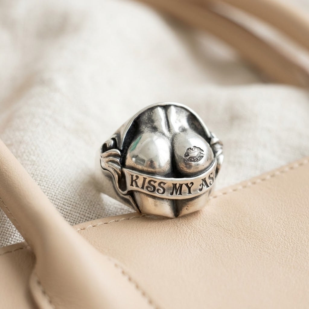 Lifestyle product shot showing the silver ring sitting tucked inside the pocket of a beige canvas handbag
