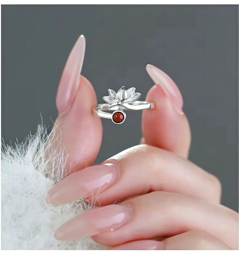 Minimalist lotus ring displayed in hand