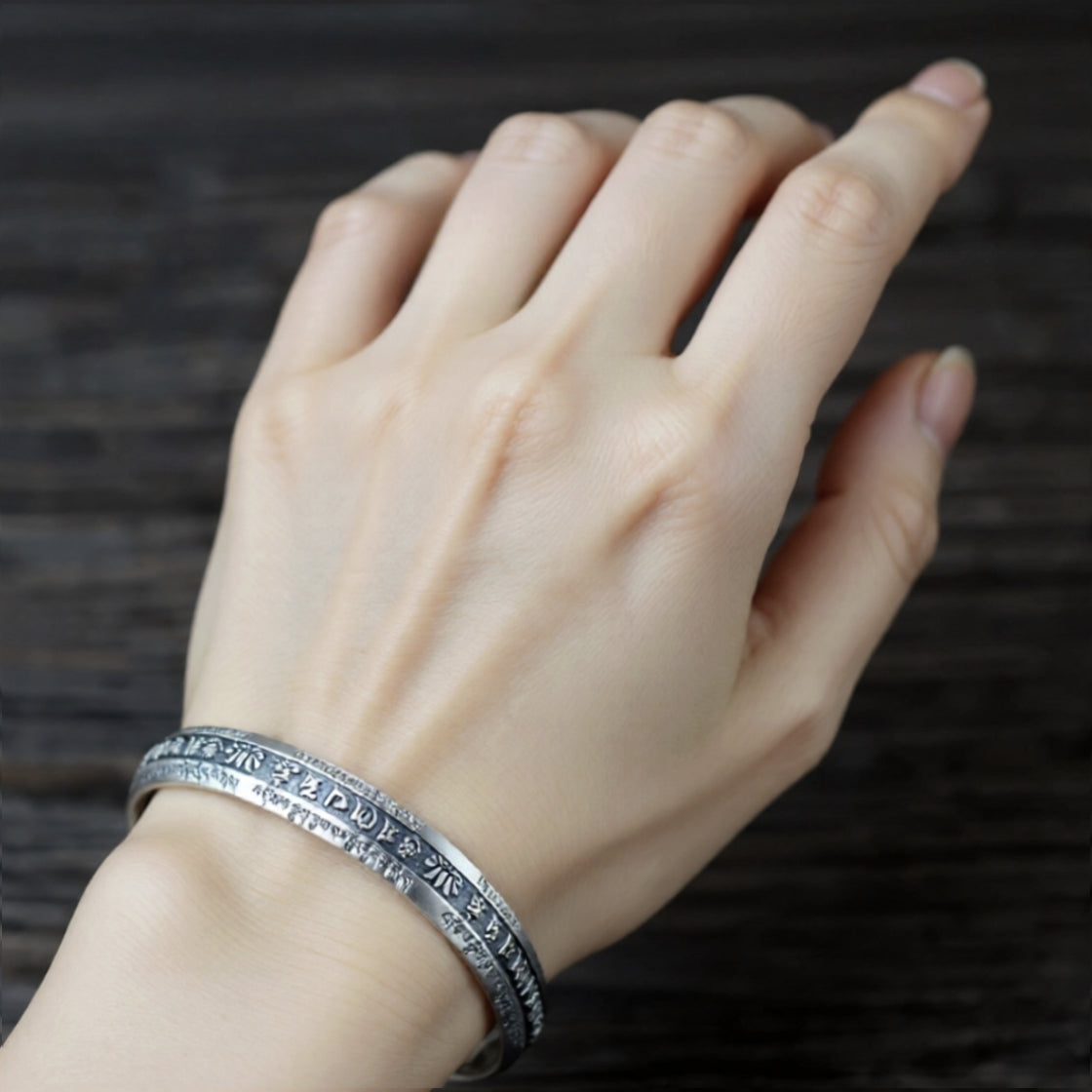 OM mantra bracelet on a model