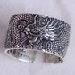 Side view showing the wide 12 mm band of the oxidized dragon ring