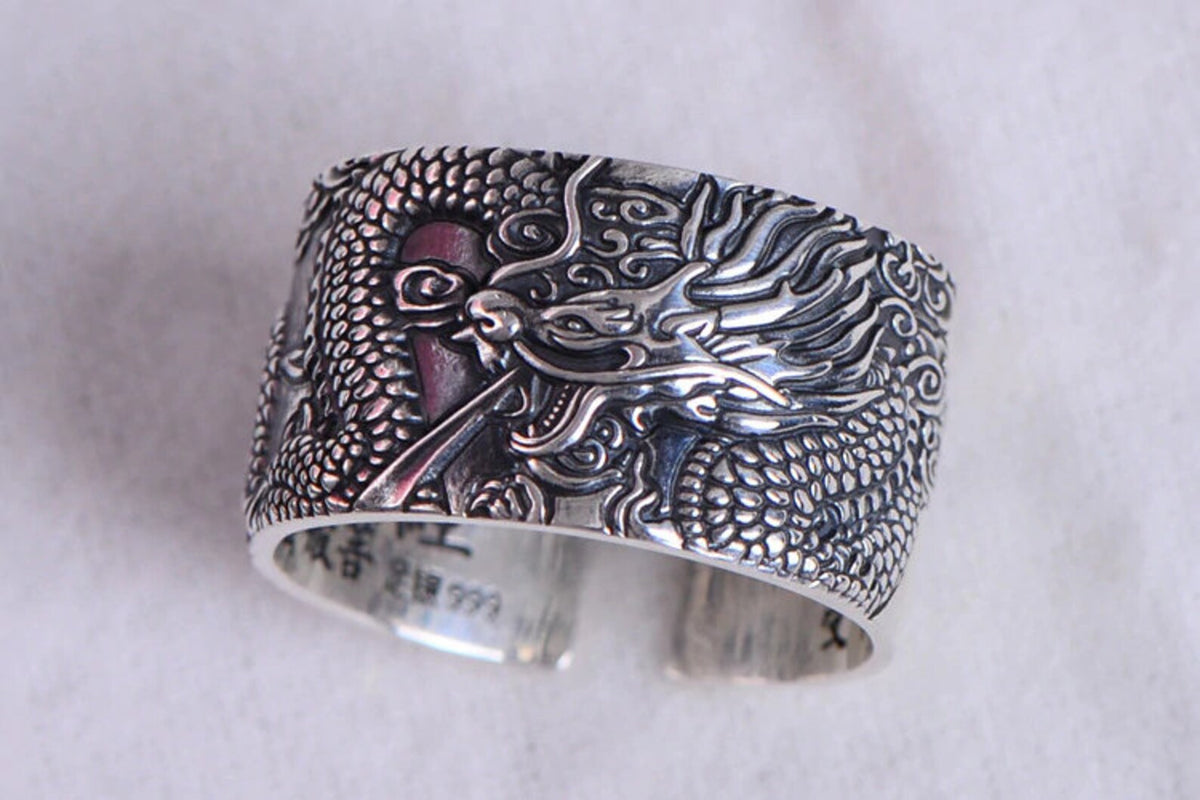 Side view showing the wide 12 mm band of the oxidized dragon ring
