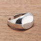 Silver signet ring on a wooden surface