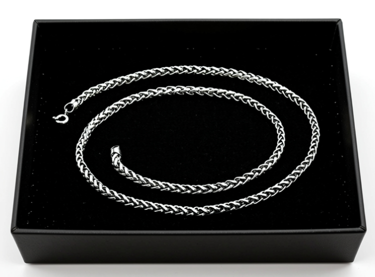 Silver braided necklace in a black display box