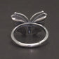 Silver butterfly ring on a dark background back side