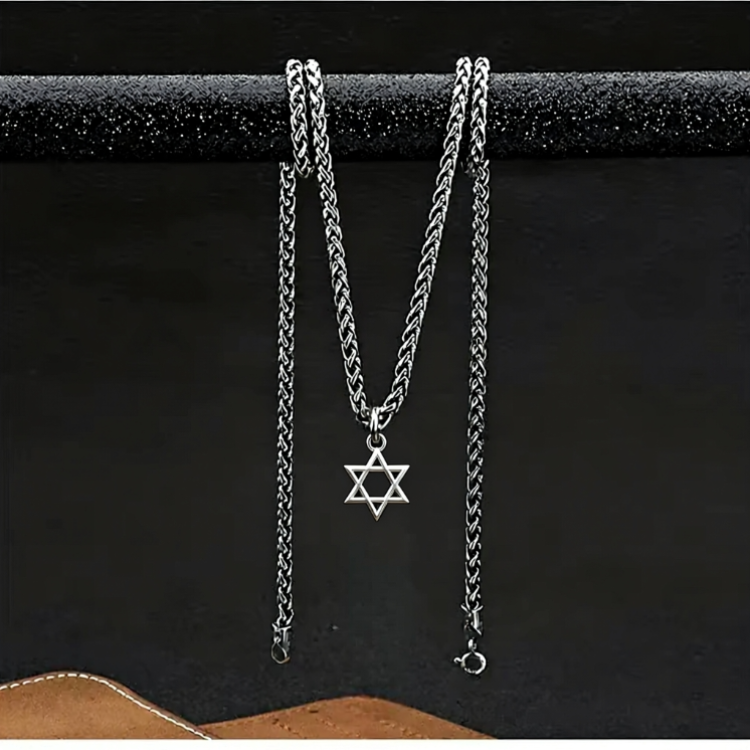 Silver chain necklace with Star of David pendant on a black background