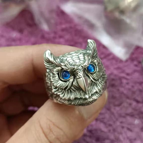 Silver owl ring on hand showing details