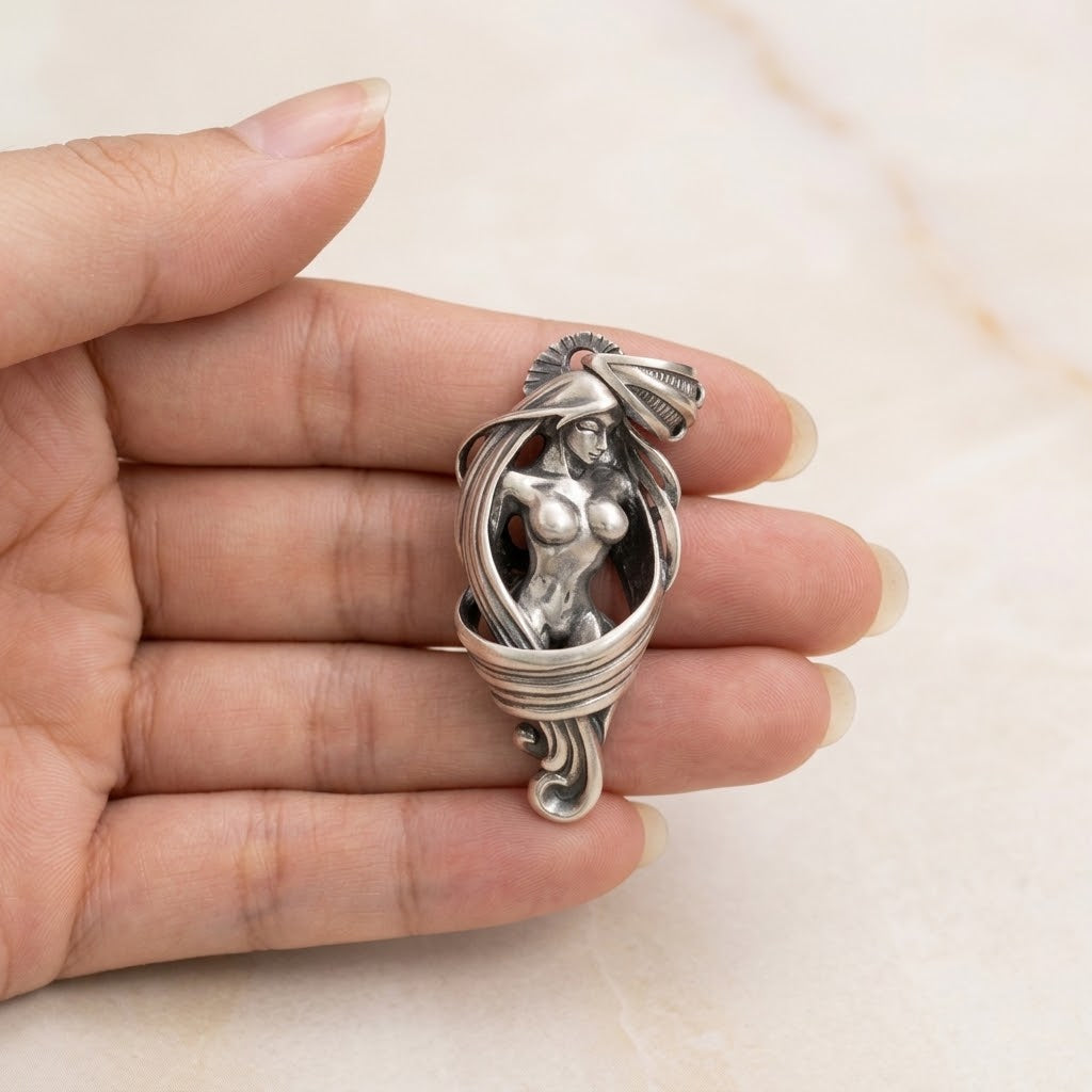 Solid silver pendant held in hand