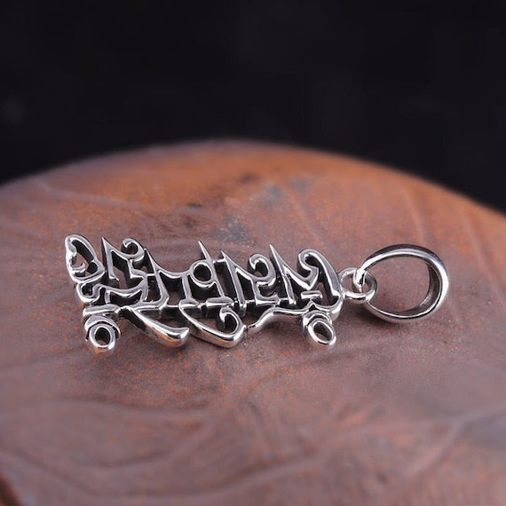 Sterling silver pendant with Tibetan symbols