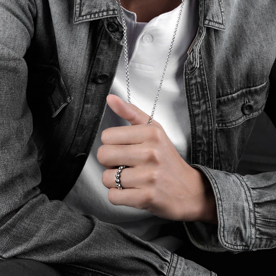 Sterling silver skull ring worn on finger