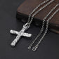Textured silver cross necklace with chain displayed on a dark surface
