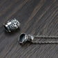 The sterling silver lotus locket pendant shown separated into its two main parts (the main body and the screw-top cap with the bail), lying on a dark wood surface