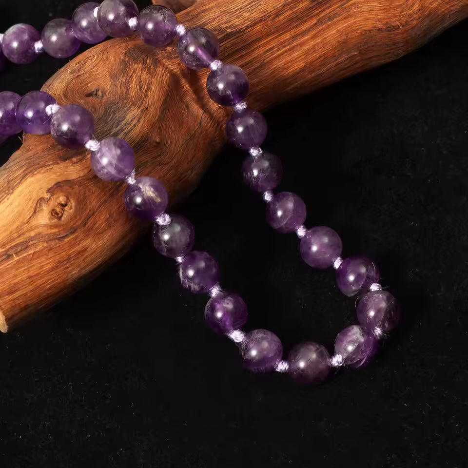 amethyst mala close up on dark background