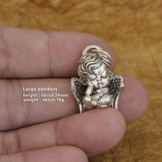 baby guardian angel pendant on hand