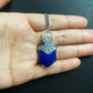 blue lapis lazuli pendant necklace on hand close up