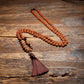 brown tassel mala necklace arranged flat