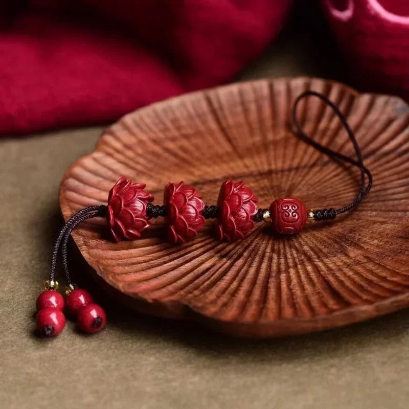 cinnabar lotus phone charm flat lay