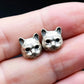 cute silver cat earrings held on hand detail