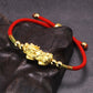 gold pixiu bracelet on dark background closeup side angle