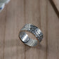 handcrafted silver ring on wooden background
