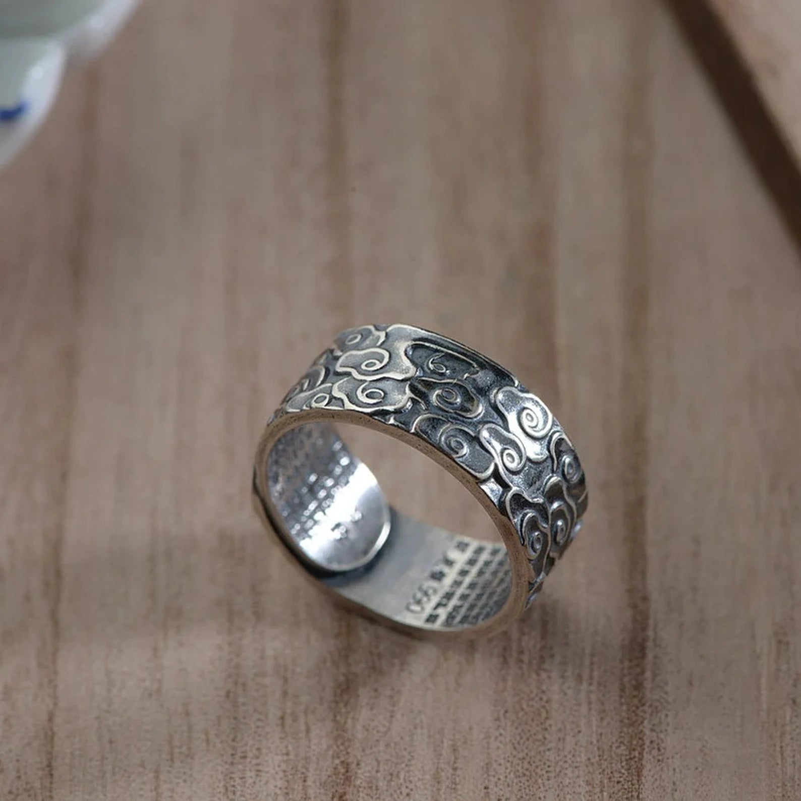 handcrafted silver ring on wooden background
