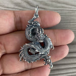 large sterling silver dragon pendant on hand