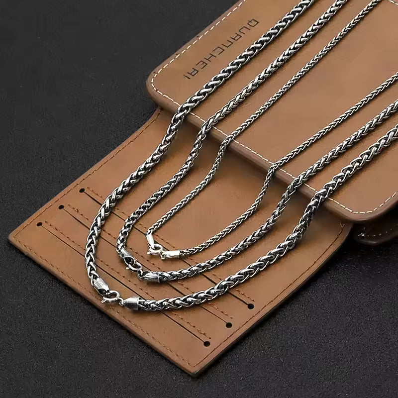 layered sterling silver chains in display