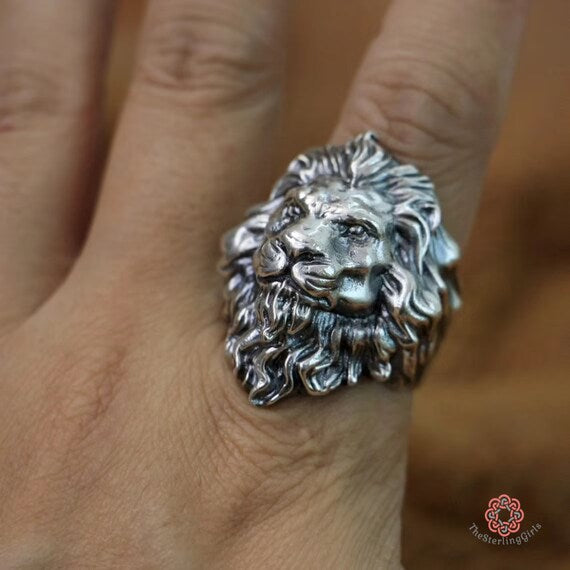 lion ring on a finger