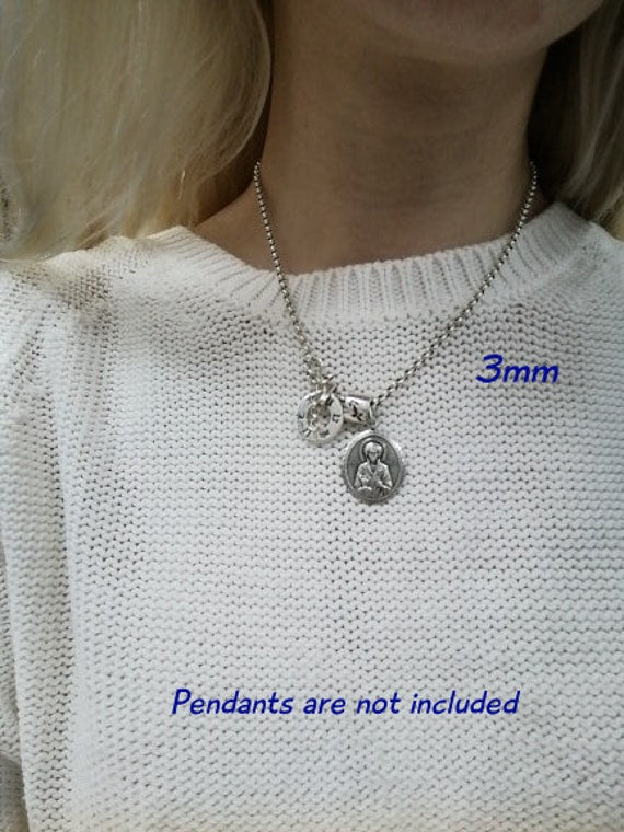 long silver chain necklace on neck