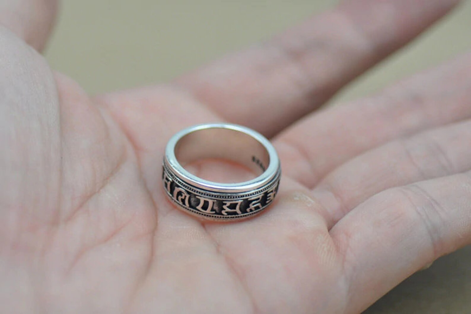 meditation spinning ring shown in palm for scale