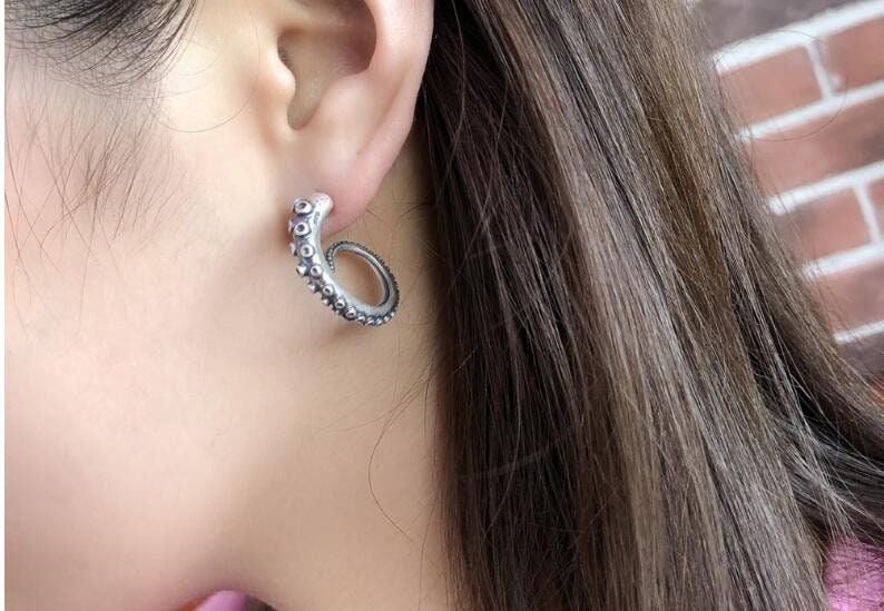 octopus tentacle earrings worn on ear