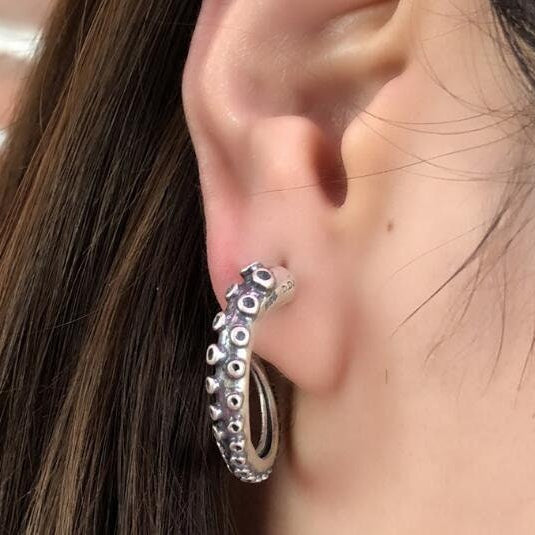octopus tentacle stud earrings on ear