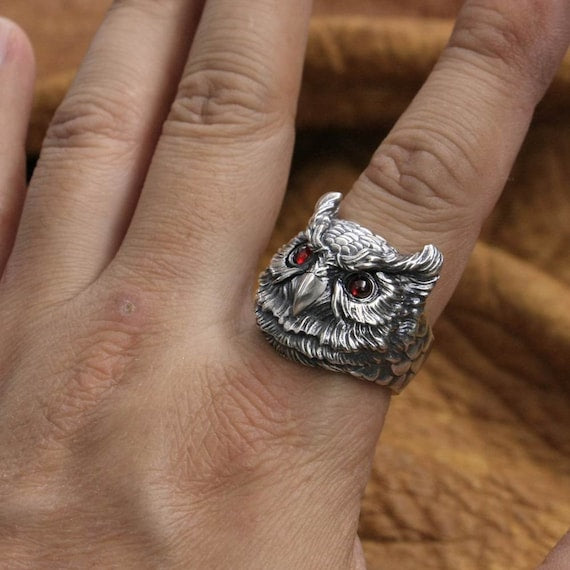 owl ring red eyes on hand