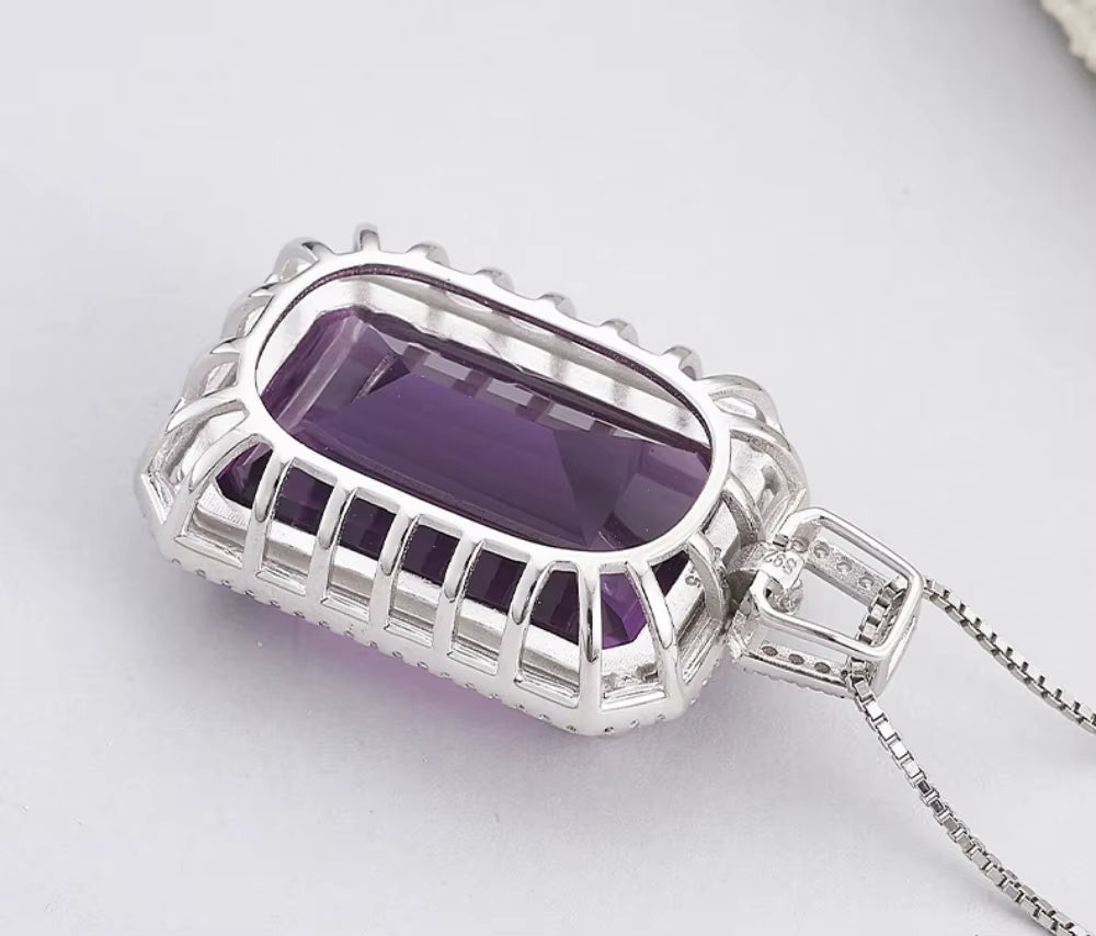 purple gemstone pendant on hand styling