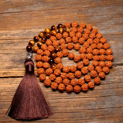 rudraksha and tiger eye mala displayed on wood