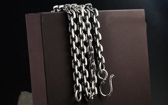 silver chain display on brown box