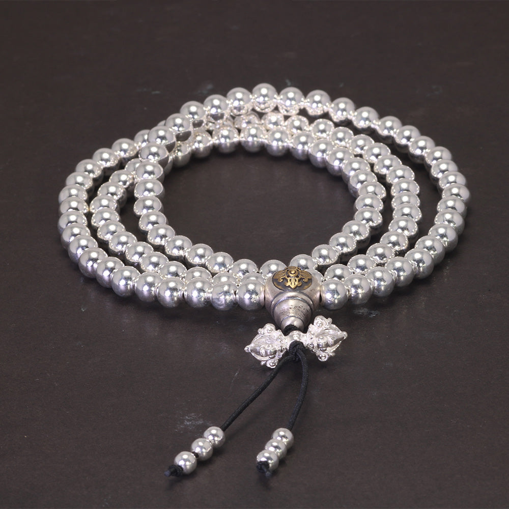 silver buddhist beads arranged in loop